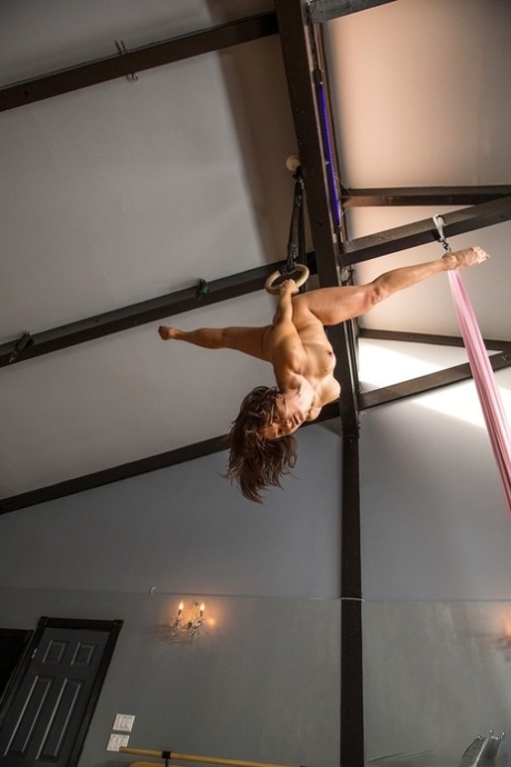 Fit MILF works up a sweat on rings before fucking a long cock