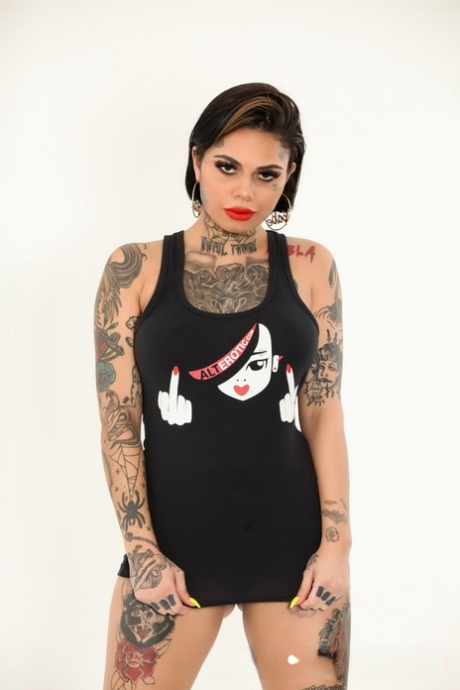 Tattooed model Genevieve Sinn looses her firm breasts from a tank top
