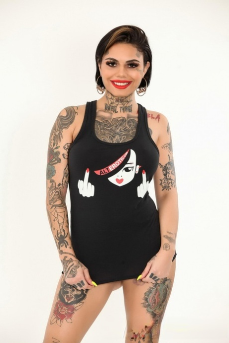Tattooed model Genevieve Sinn looses her firm breasts from a tank top