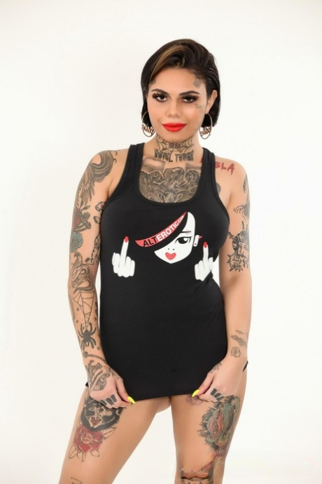 Tattooed model Genevieve Sinn looses her firm breasts from a tank top