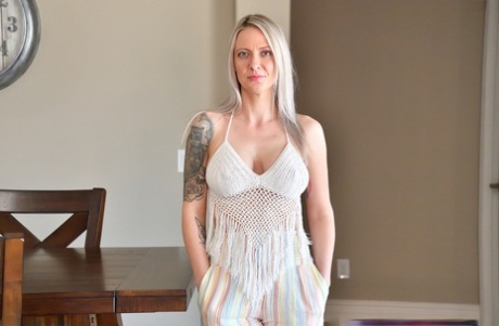 Platinum blonde MILF Kitten fingers and spreads her pink pussy on a sofa