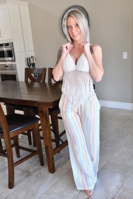 Platinum blonde MILF Kitten fingers and spreads her pink pussy on a sofa