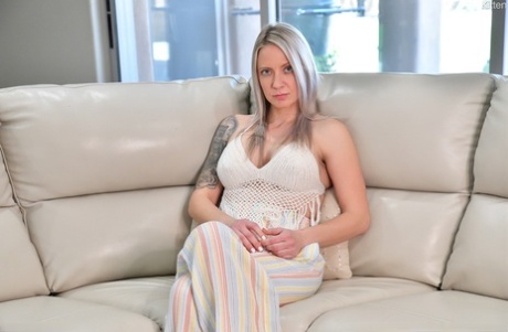 Platinum blonde MILF Kitten fingers and spreads her pink pussy on a sofa