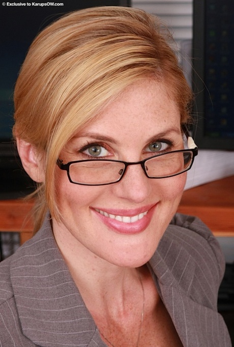 Horny blonde secretary Kate removes her glasses her clothing to spread at work