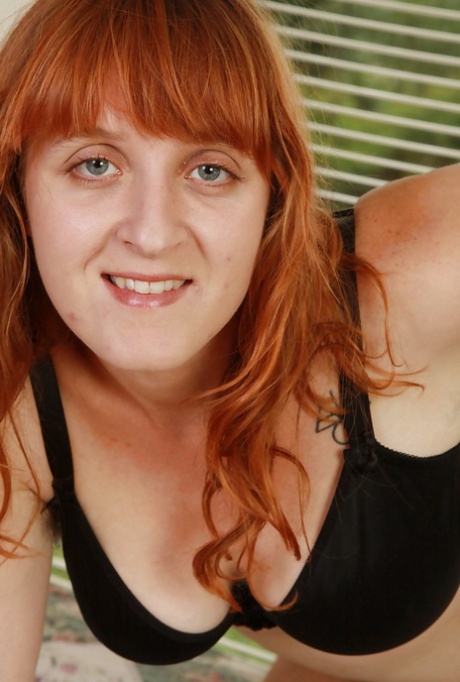 Ugly redhead MILF tweaking her nipples and exposing her shaggy twat