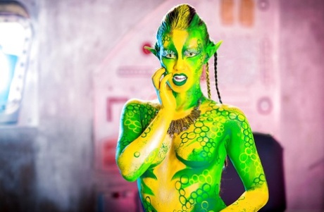 Kinky cosplay chick Tiffany Doll posing in body paint uniform and spreading