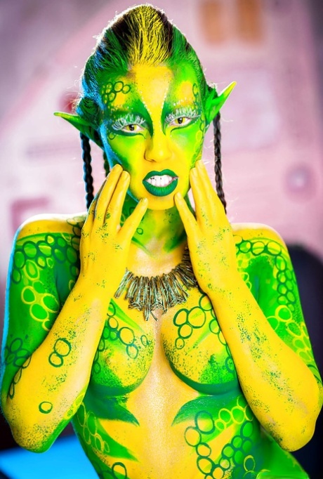 Kinky cosplay chick Tiffany Doll posing in body paint uniform and spreading