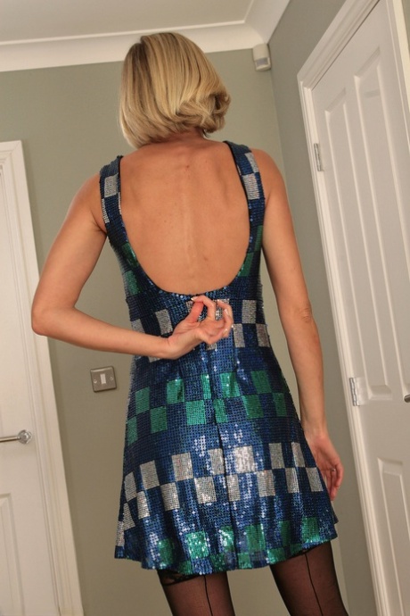 Tall mature MILF Erin L strips down to her stockings & flaunts her small tits