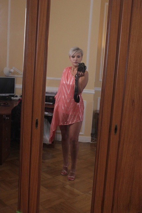 Short-haired stunner Oxy Summer poses provocatively in her sexy long dress