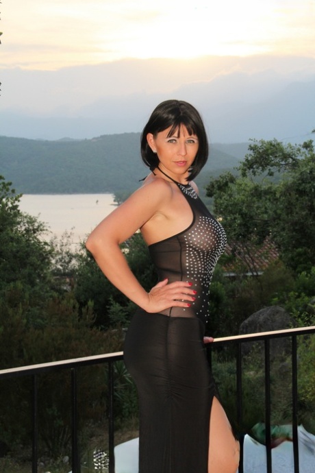 German MILF Desyra Noir shows her big tits & ass in her long dress & tights