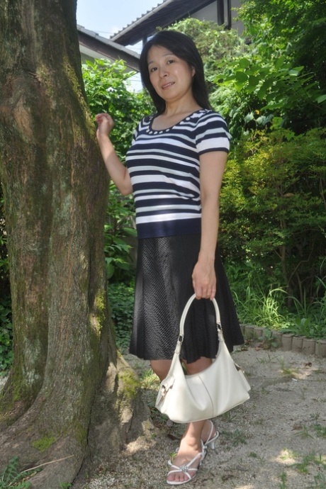 Petite Japanese granny Akiko Oda strips and shows her bushy wet beaver
