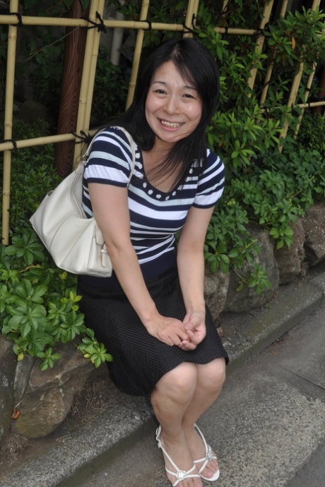 Petite Japanese granny Akiko Oda strips and shows her bushy wet beaver