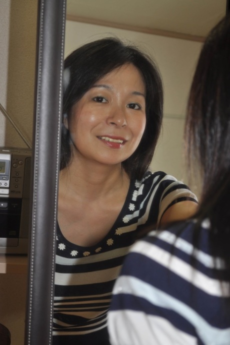 Petite Japanese granny Akiko Oda strips and shows her bushy wet beaver