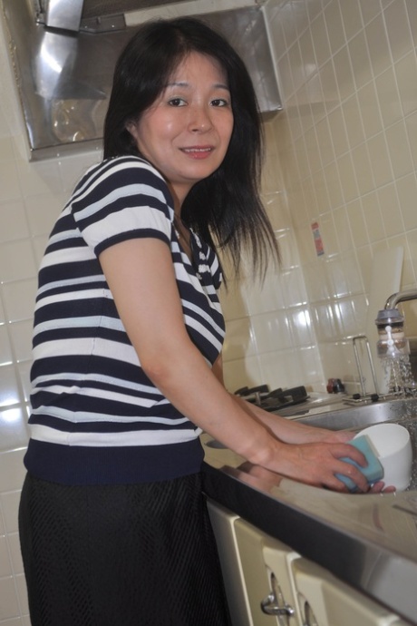 Petite Japanese granny Akiko Oda strips and shows her bushy wet beaver