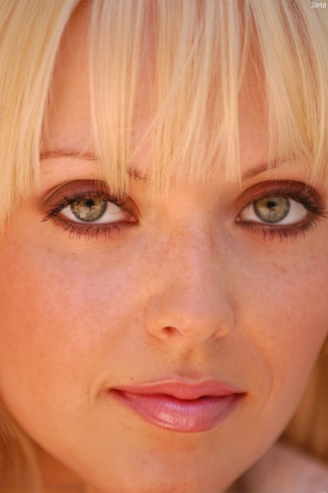 Green-eyed babe Jana strips off her sexy outfit & masturbates with a glass toy